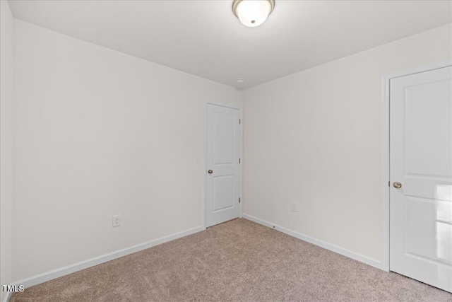 unfurnished room with light colored carpet