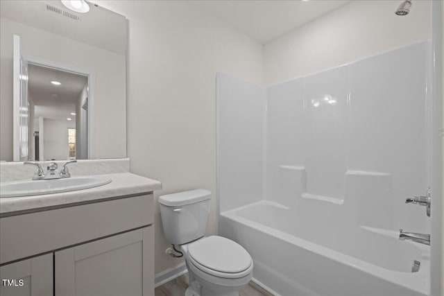 full bathroom with shower / tub combination, vanity, wood-type flooring, and toilet