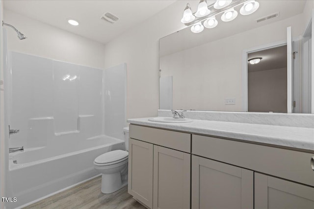 full bathroom featuring toilet, vanity, shower / bathtub combination, and hardwood / wood-style flooring