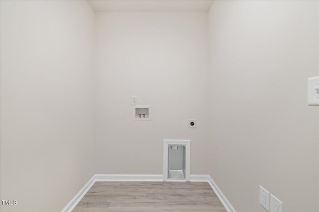 washroom with electric dryer hookup, washer hookup, and light wood-type flooring