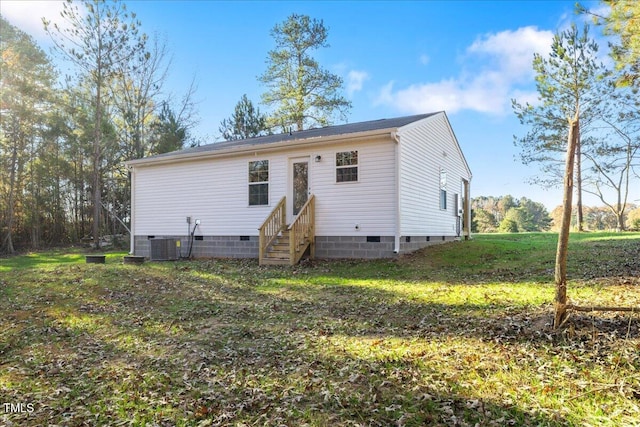 rear view of house with a yard