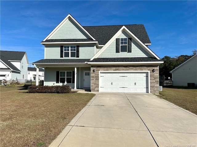 craftsman inspired home with central air condition unit, a front lawn, a porch, and a garage