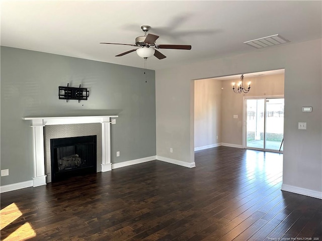 unfurnished living room featuring dark hardwood / wood-style flooring and ceiling fan with notable chandelier