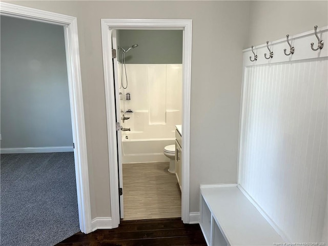 full bathroom featuring hardwood / wood-style floors, vanity, shower / bathtub combination, and toilet