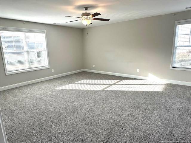 carpeted spare room featuring ceiling fan