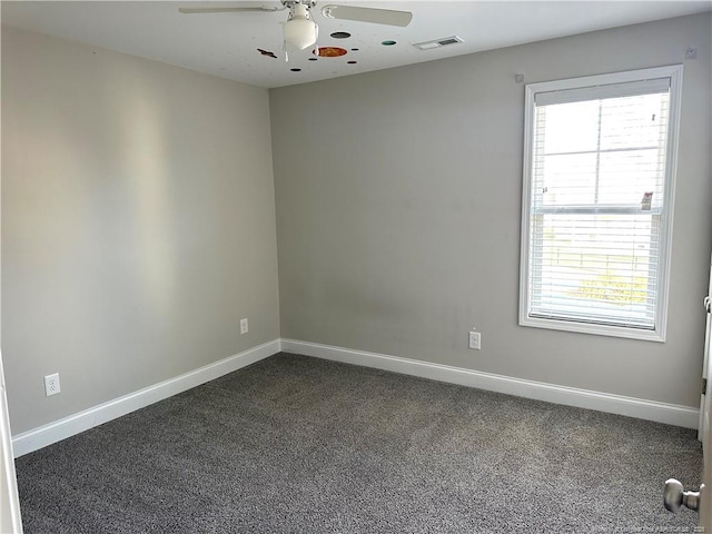 carpeted empty room featuring ceiling fan