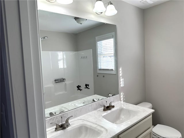 full bathroom featuring vanity, toilet, and washtub / shower combination