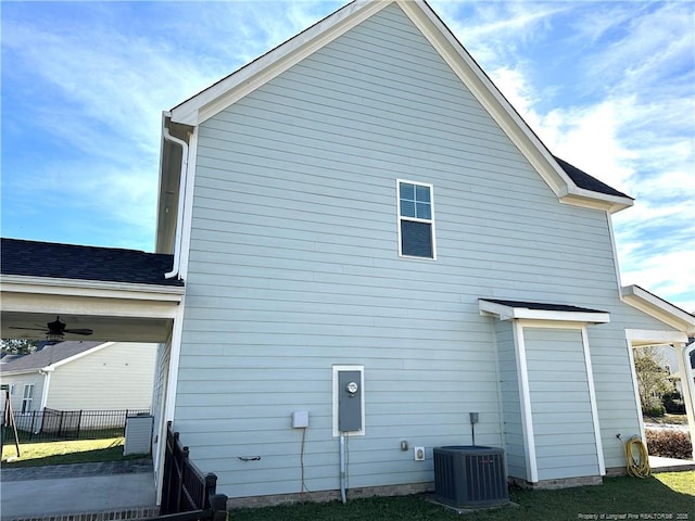 view of side of property with ceiling fan and cooling unit