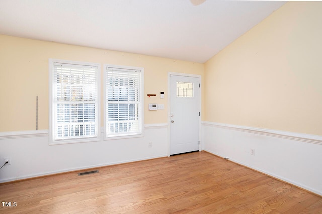 foyer featuring light hardwood / wood-style flooring and lofted ceiling