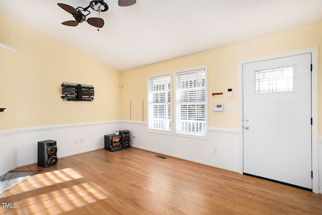 entryway featuring lofted ceiling, ceiling fan, and light wood-type flooring