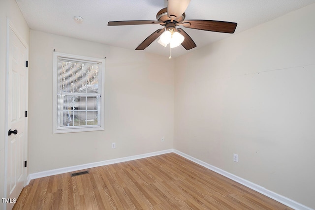 unfurnished room featuring ceiling fan, light wood-type flooring, and a textured ceiling