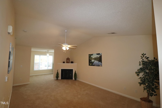 unfurnished living room with ceiling fan, lofted ceiling, and light carpet