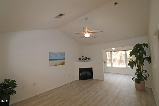 unfurnished living room with ceiling fan, vaulted ceiling, and light wood-type flooring