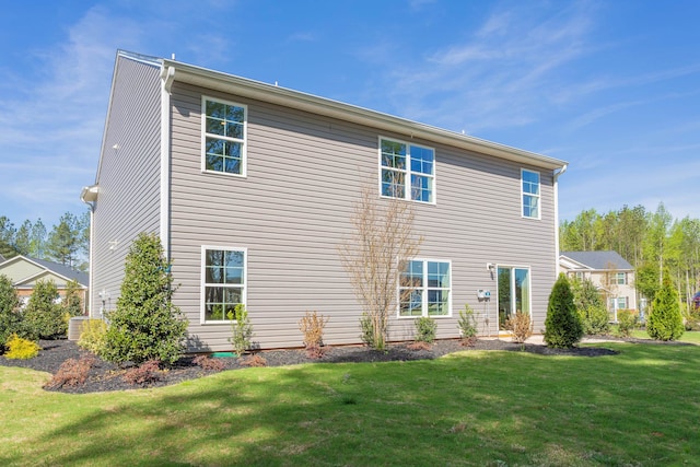 rear view of property with a lawn