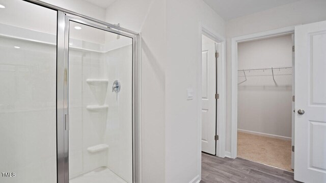 bathroom featuring hardwood / wood-style floors and an enclosed shower