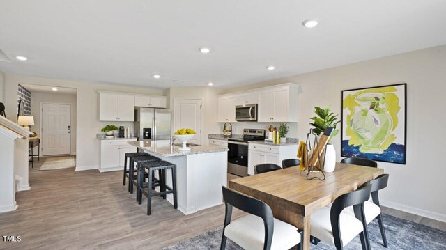 dining space featuring light hardwood / wood-style floors