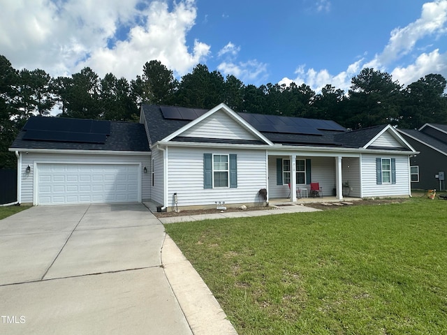 view of front facade featuring covered porch, solar panels, a garage, and a front yard