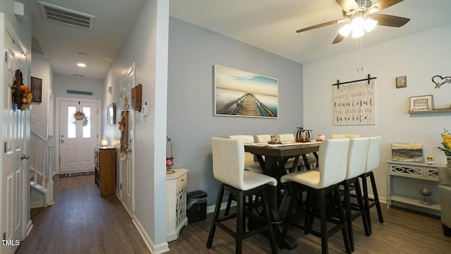 dining space featuring dark hardwood / wood-style floors and ceiling fan