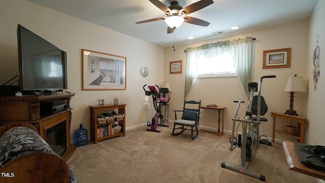 workout room with light carpet and ceiling fan