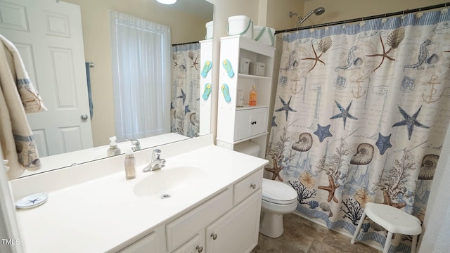 bathroom with walk in shower, vanity, and toilet