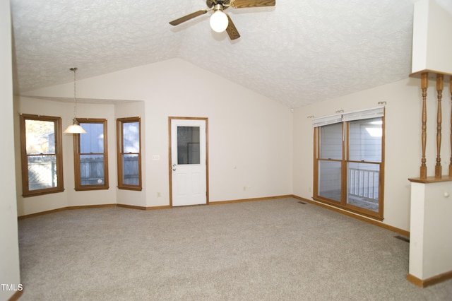 unfurnished living room with a textured ceiling, ceiling fan, light colored carpet, and vaulted ceiling