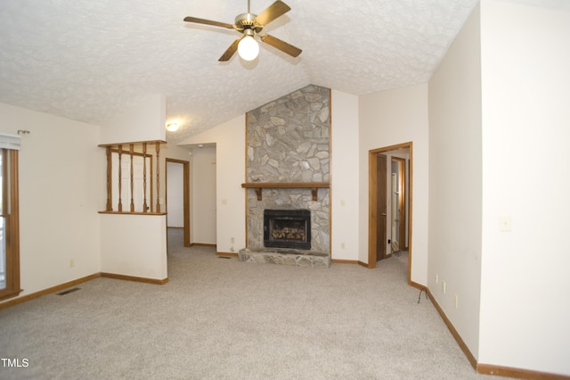 unfurnished living room featuring a textured ceiling, light colored carpet, ceiling fan, a fireplace, and lofted ceiling