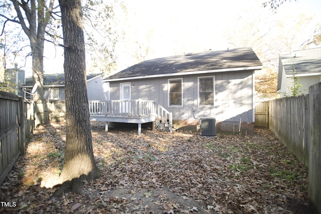 back of house featuring central AC and a wooden deck