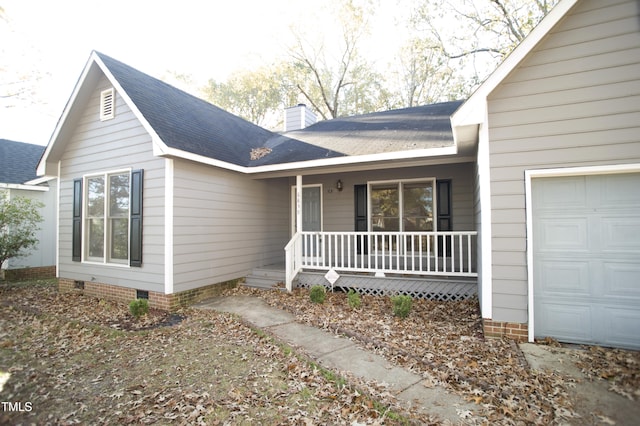 exterior space with a porch and a garage