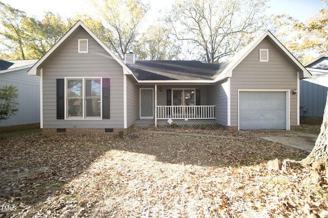 ranch-style home featuring covered porch and a garage