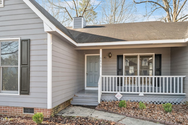 property entrance with visible vents, a shingled roof, covered porch, a chimney, and crawl space