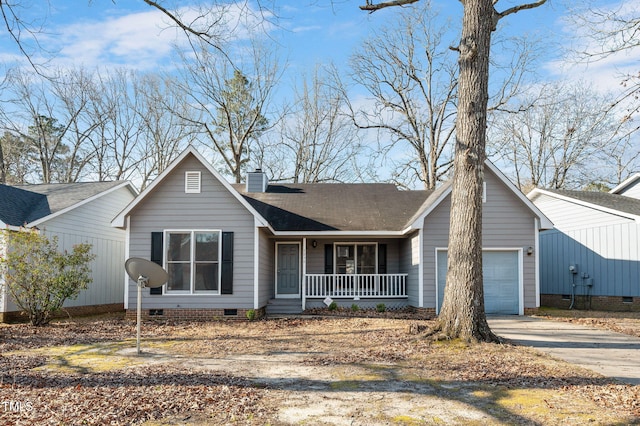 view of front of home with covered porch, a chimney, a garage, crawl space, and driveway