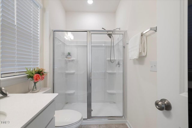 bathroom with vanity, an enclosed shower, and toilet