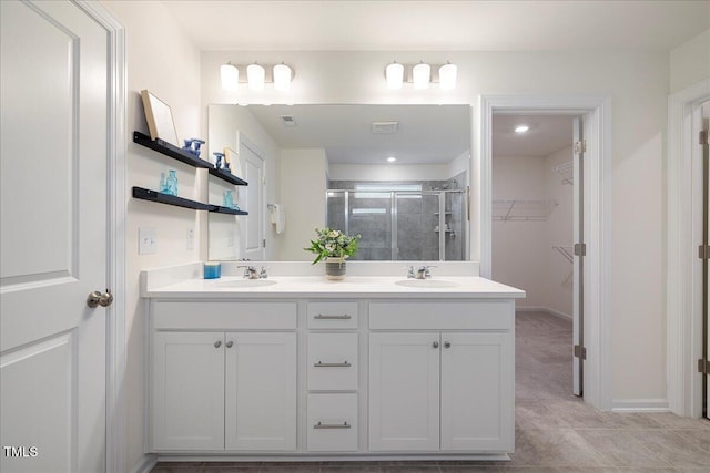 bathroom with tile patterned flooring, vanity, and walk in shower