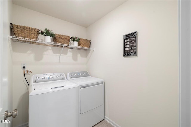 clothes washing area with washing machine and clothes dryer