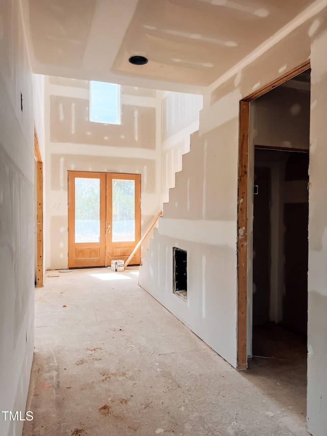 unfurnished living room featuring french doors