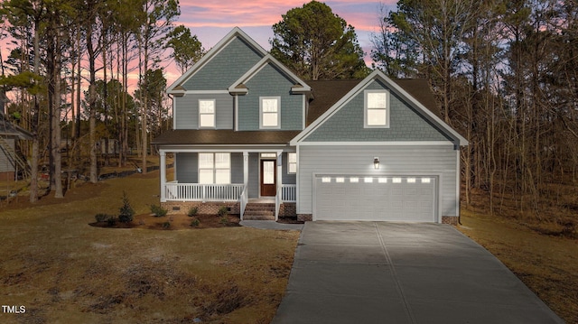 view of front of property featuring a garage and covered porch