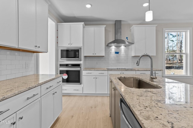 kitchen featuring white cabinetry, wall chimney exhaust hood, and appliances with stainless steel finishes