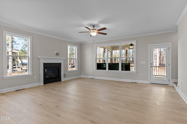 unfurnished living room featuring ceiling fan, ornamental molding, and light wood-type flooring