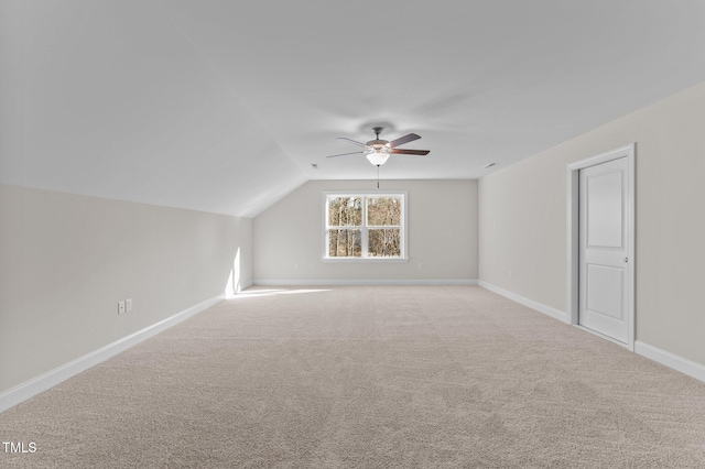 bonus room with light carpet, vaulted ceiling, and ceiling fan