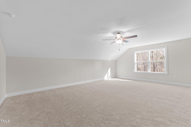 additional living space featuring light carpet, vaulted ceiling, and ceiling fan