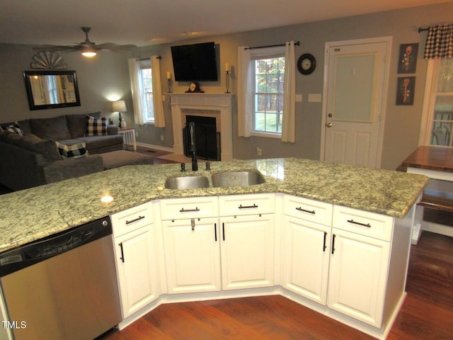 kitchen featuring dark wood-type flooring, white cabinets, stainless steel dishwasher, ceiling fan, and kitchen peninsula