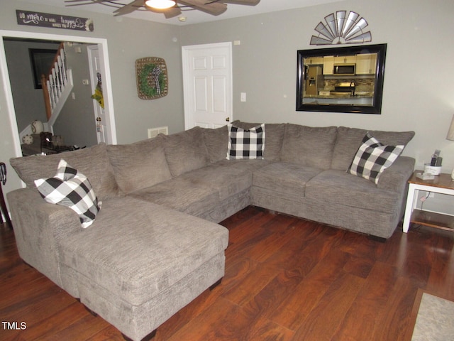 living room with dark hardwood / wood-style floors and ceiling fan