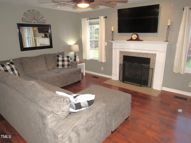 living room with ceiling fan, dark hardwood / wood-style flooring, and a fireplace