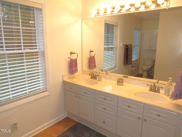 bathroom with tile patterned floors, vanity, and toilet