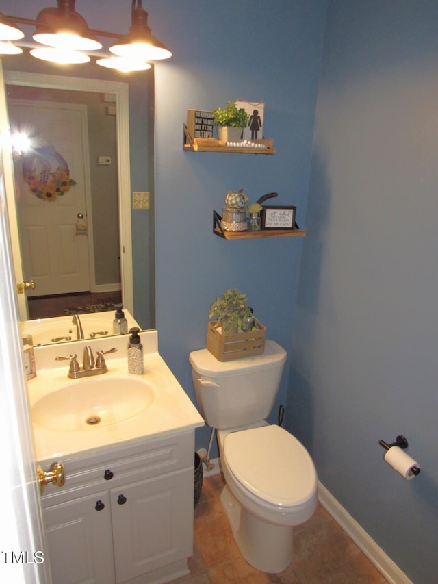 bathroom featuring tile patterned floors, vanity, and toilet