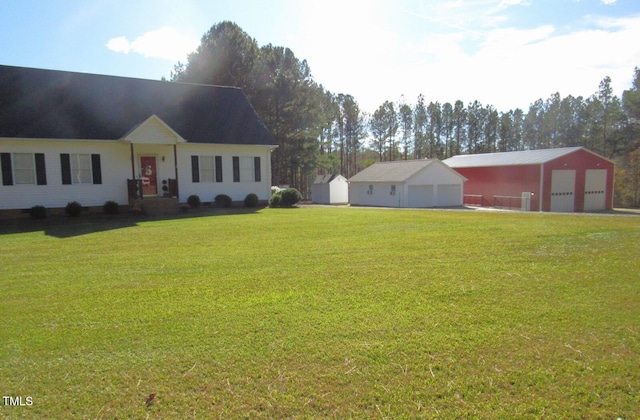 view of front of house with an outbuilding, a front lawn, and a garage