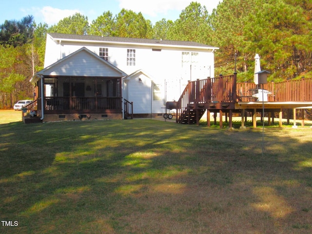 back of house featuring a lawn, a sunroom, and a deck