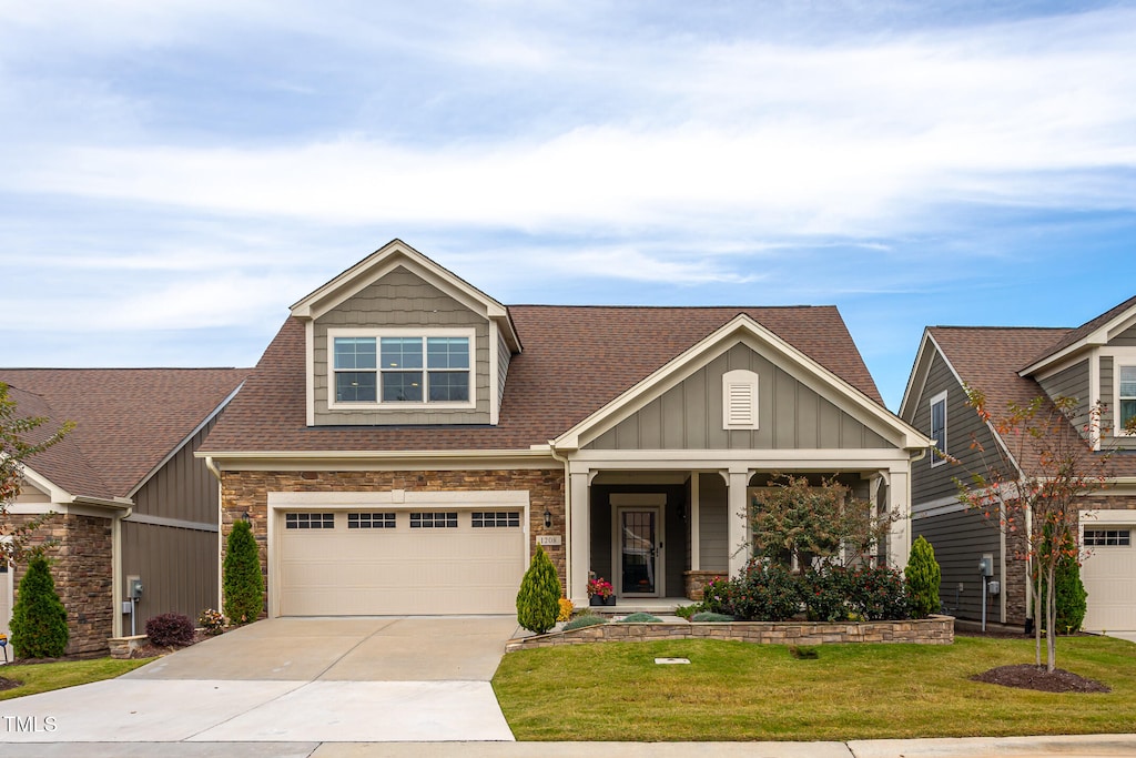 craftsman-style house with a front lawn and a garage