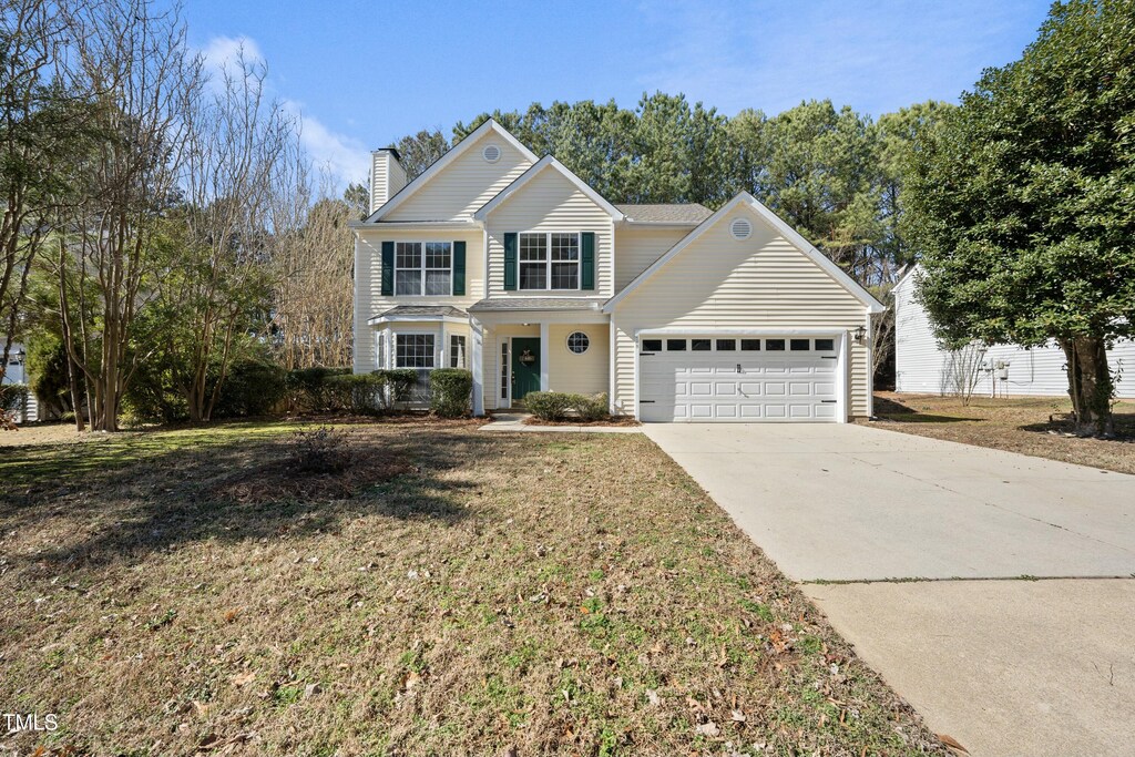 front of property featuring a garage and a front lawn