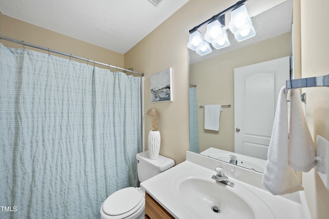 bathroom featuring vanity, toilet, a shower with shower curtain, and a textured ceiling